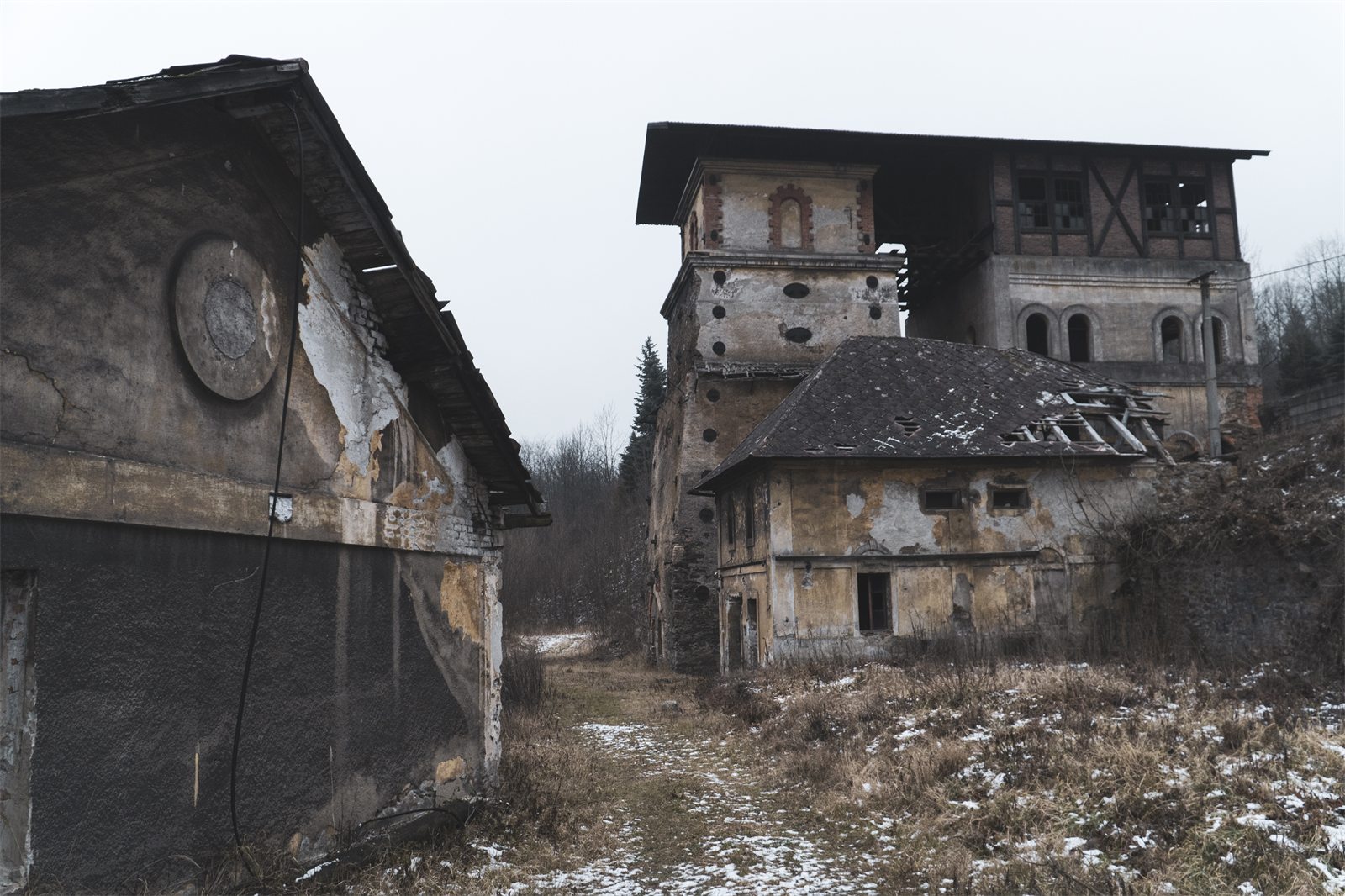Disused historic blast furnace and industrial buildings in a wooded valley in winter